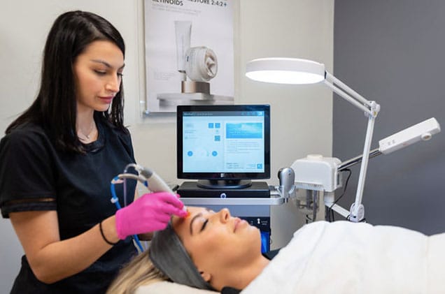 Staff of KP Aesthetics does a facial on a client.