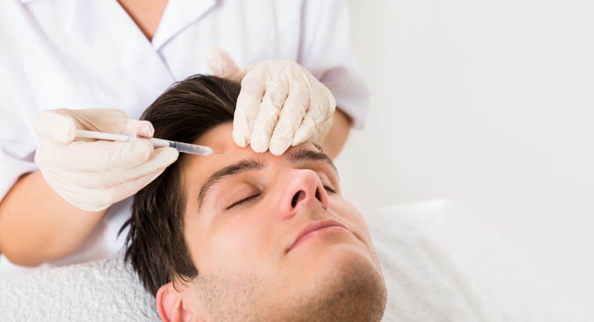 a handsome man getting facial treatment