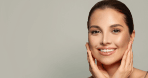 a beautiful woman smiling while holding her chin