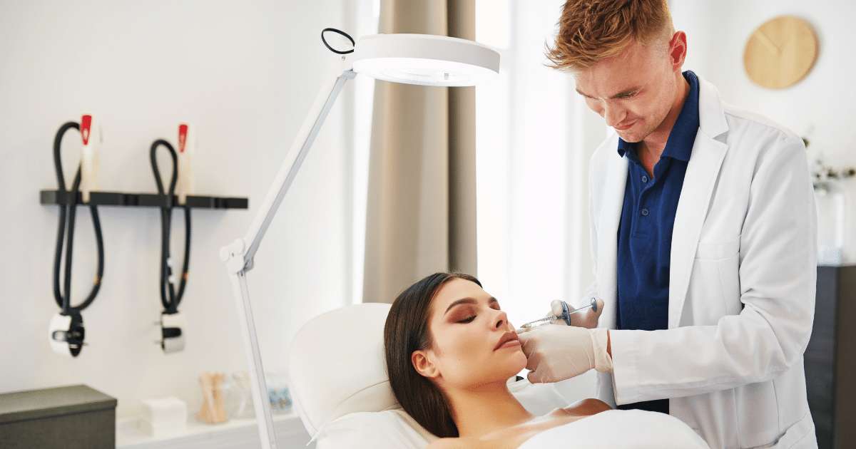 A photo of a woman lying while receiving a Masseter Botox injected by a male doctor.