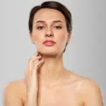 Dermatology aesthetic feminine apply trap Botox injection clean clear sensual healthy gel balm back concept. Close up half-turned portrait of beautiful lady with flawless skin isolated background